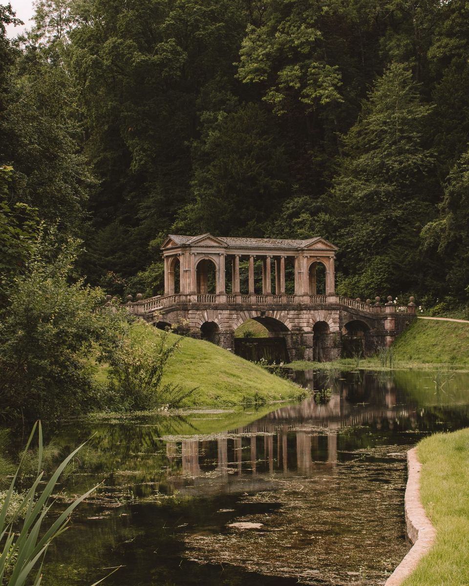 Palladian bridge reflected in a still lake at Prior Park
